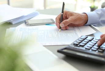 Tax accountant working with documents at table