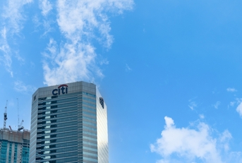 Citibank skyscraper against a blue sky with clouds
