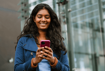 Woman looking at phone in city