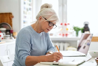 senior waman sitting at the table