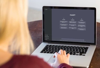 woman using chatgpt on laptop