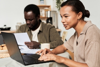Couple using computer to do taxes