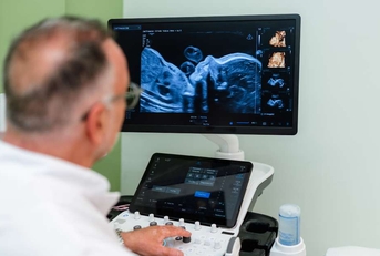 gynecologist using modern ultrasound scanner