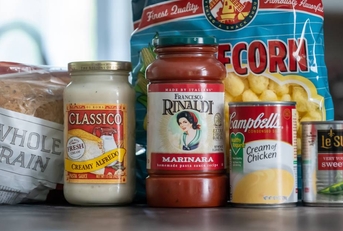 Several containers of grocery food products on kitchen counter