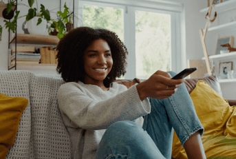 person with remote control in hand