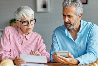 senior couple checking bills