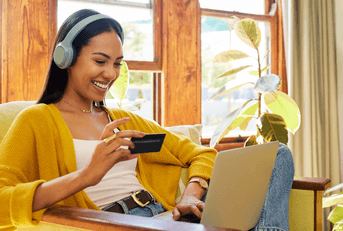 Girl on laptop with debit card