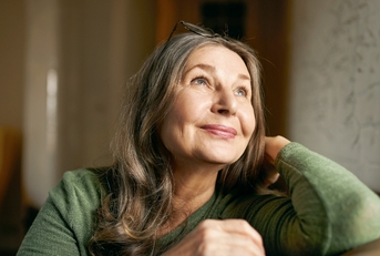 Older woman smiling and looking up