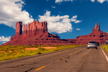 Cars on highway in Monument Valley, Utah