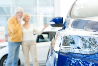 Senior couple choosing a new car to buy
