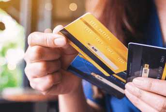 Woman holding and choosing credit card
