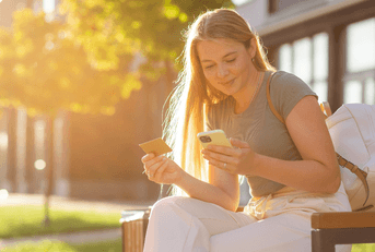 Woman using credit card on her phone