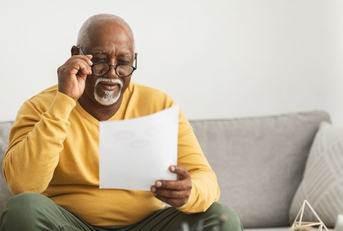 older man reviewing paper