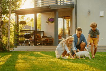 Family in yard with house in background