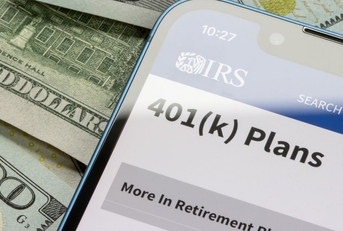 401(k) plans IRS site on phone with cash background