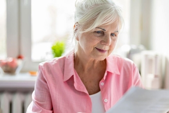 older woman reviewing papers