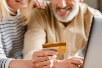 Older couple using a credit card online
