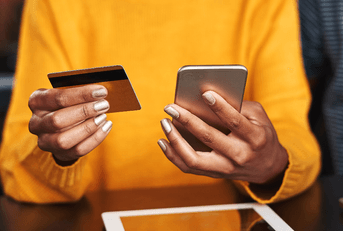 Woman using credit card on cellphone