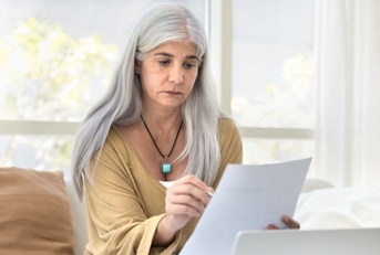 older woman reviewing papers
