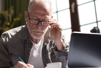concentrated older man on laptop
