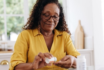 older woman taking prescription pills