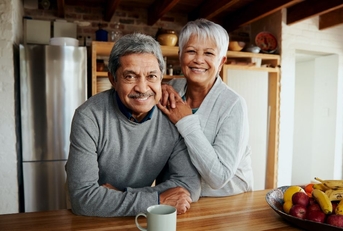 smiling older couple in kitchen