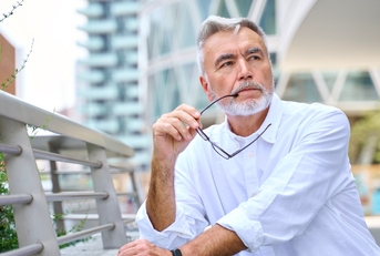 Older man in the city stop and thinking