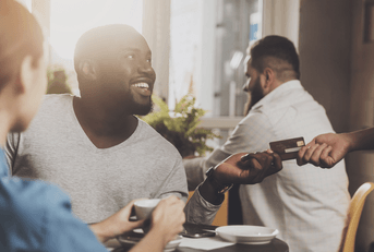 Man using credit card at restaurant