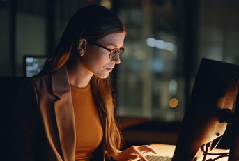 Woman looking at stocks on computer