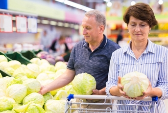 Mature couple doing groceries