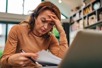 Woman looking stressed over finances