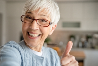 An older woman with a thumbs up