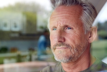 Portrait of a mature man looking out the window