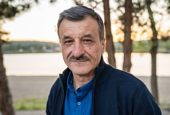 Portrait of a man in his 60s near a lake