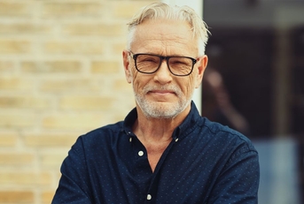 Portrait of a man in his 60s in glasses