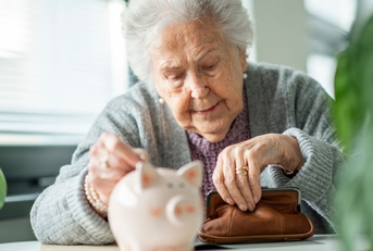 Elderly woman with a coin pouch and piggy bank