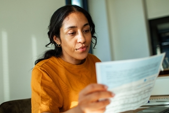 Woman looking at tax document