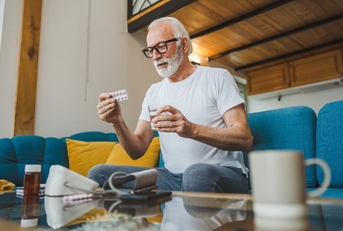 Senior man taking his medication