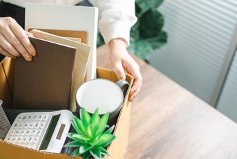 Woman with box of office supplies