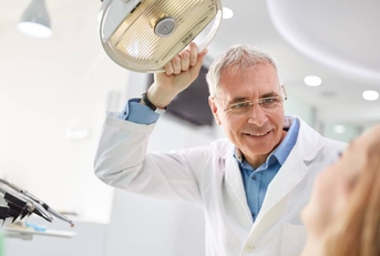 Senior man working as dentist