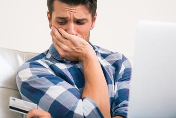 upset man holding credit card