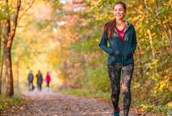woman walking in autumn forest