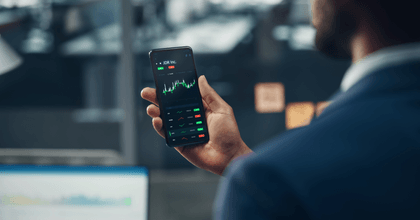 Man holding a phone showing a stock market chart