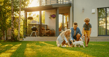 Family in yard with house in background