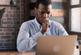 Man looking at computer and thinking