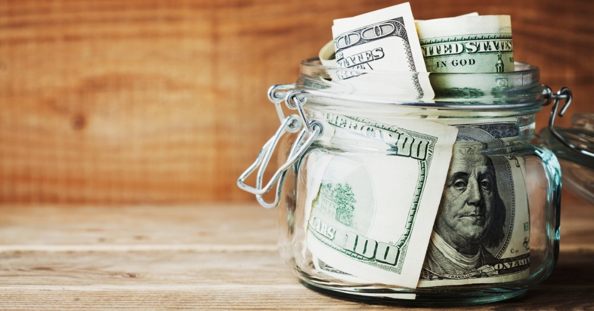 savings dollar in glass jar