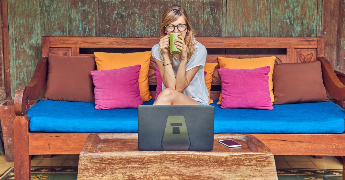 Woman drinking coffee at computer
