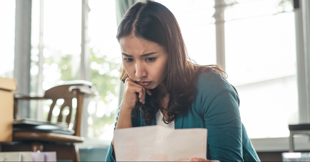 Worried woman looking at paperwork