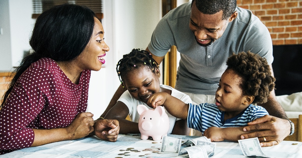 Family saving money to piggy bank