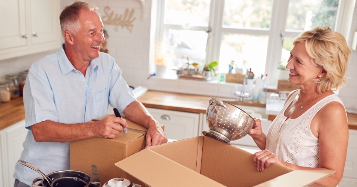 Senior couple packing kitchen